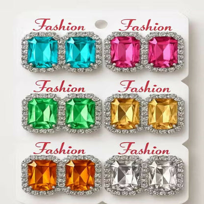Assortment of vibrant emerald cut crystal stud earrings in various colors.