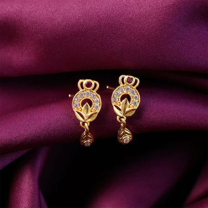 Close-up of gold floral earrings with ruby and white stones