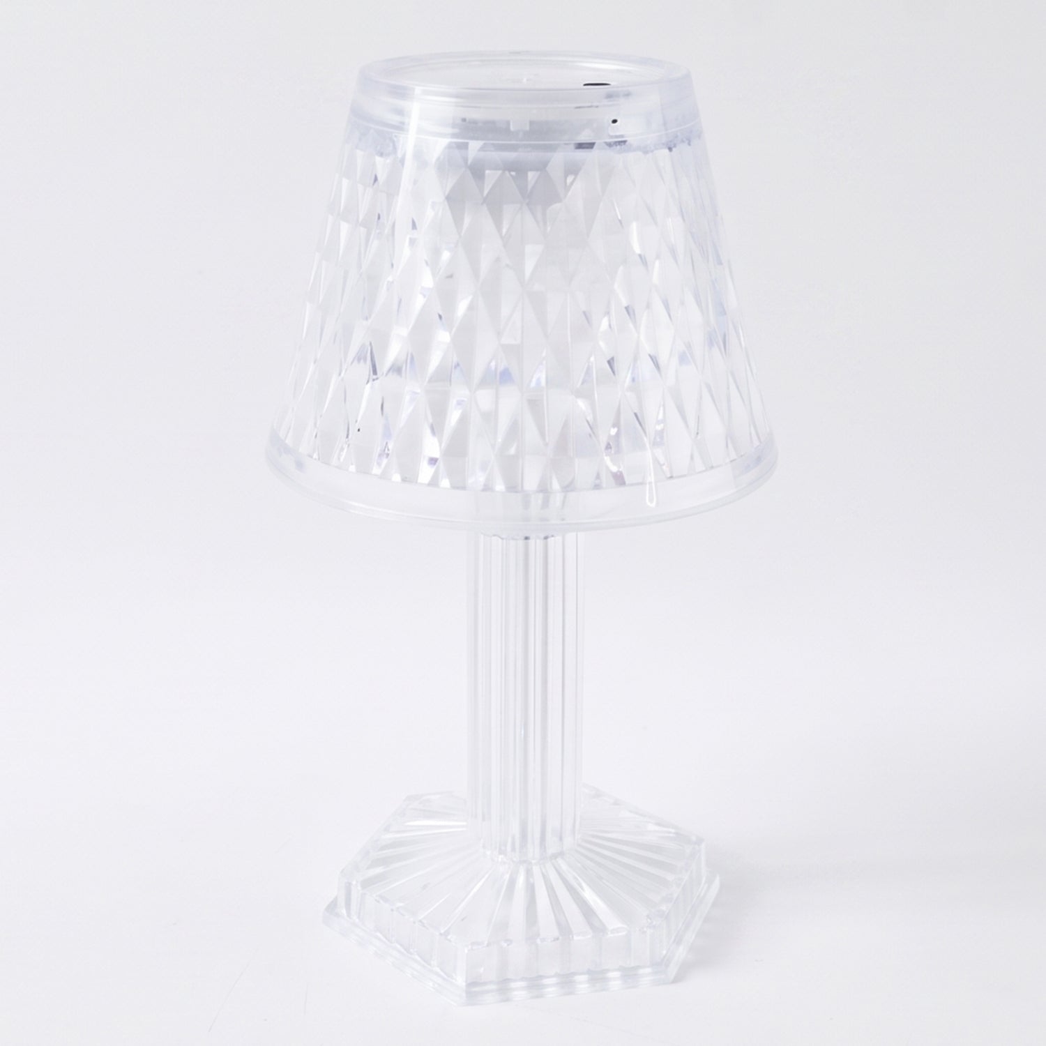 Crystal table lamp on a shelf, lit up