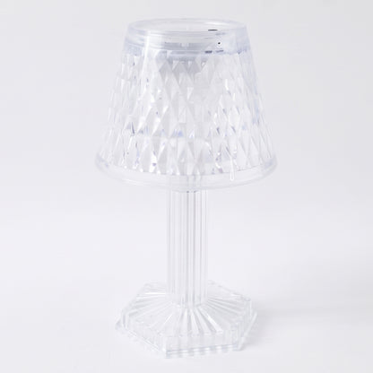 Crystal table lamp on a shelf, lit up
