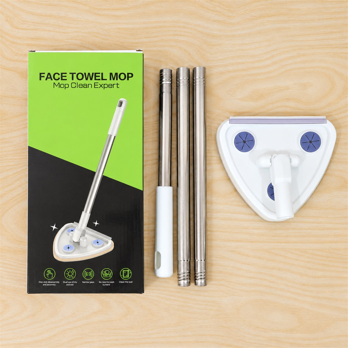 The mop components, including the handle, triangular head, and green and black packaging, are laid out on a wooden surface.