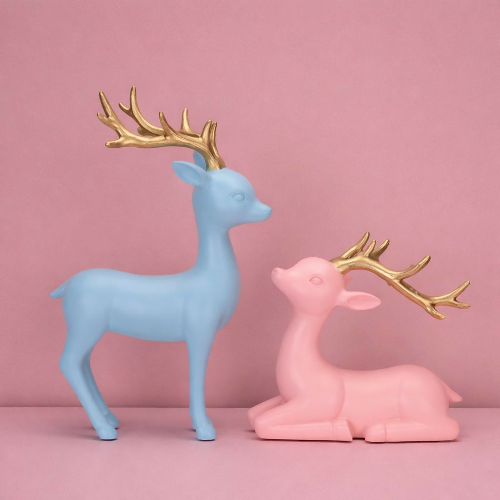 Resting pastel deer figurine with golden antlers