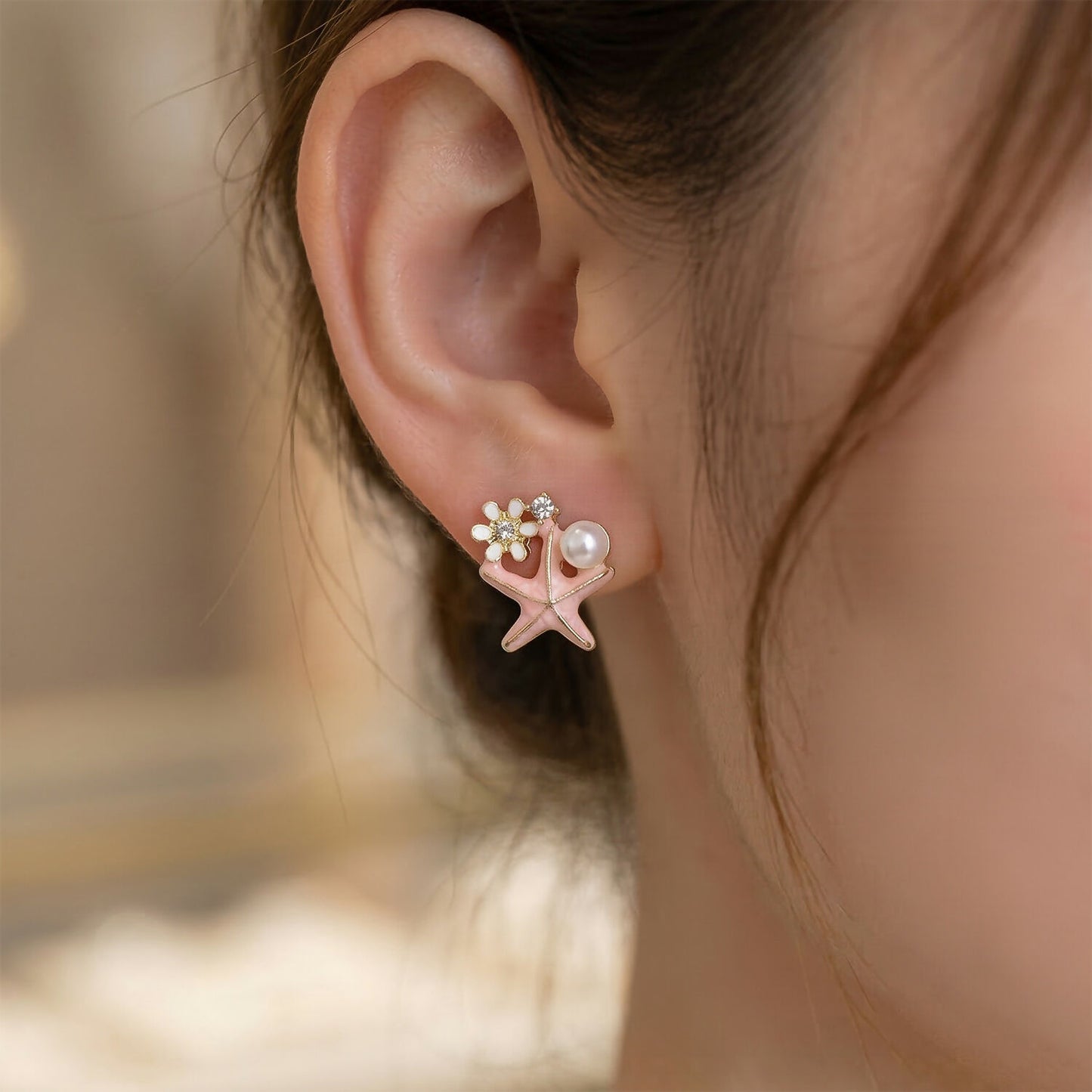 Pink starfish pearl earrings close-up detail