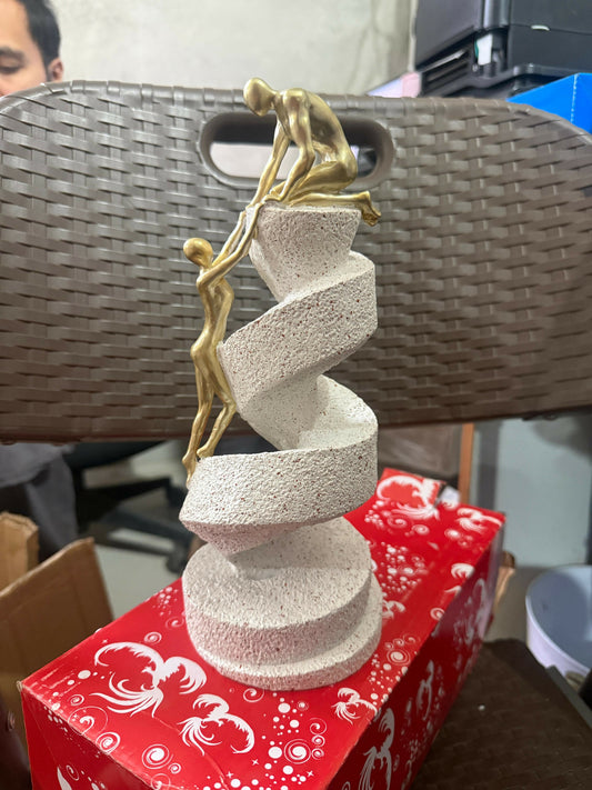 Abstract helping hands sculpture showing spiral staircase design