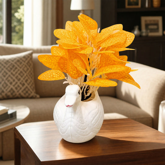 Close-up of the white ceramic swan-shaped vase with detailed embossed design