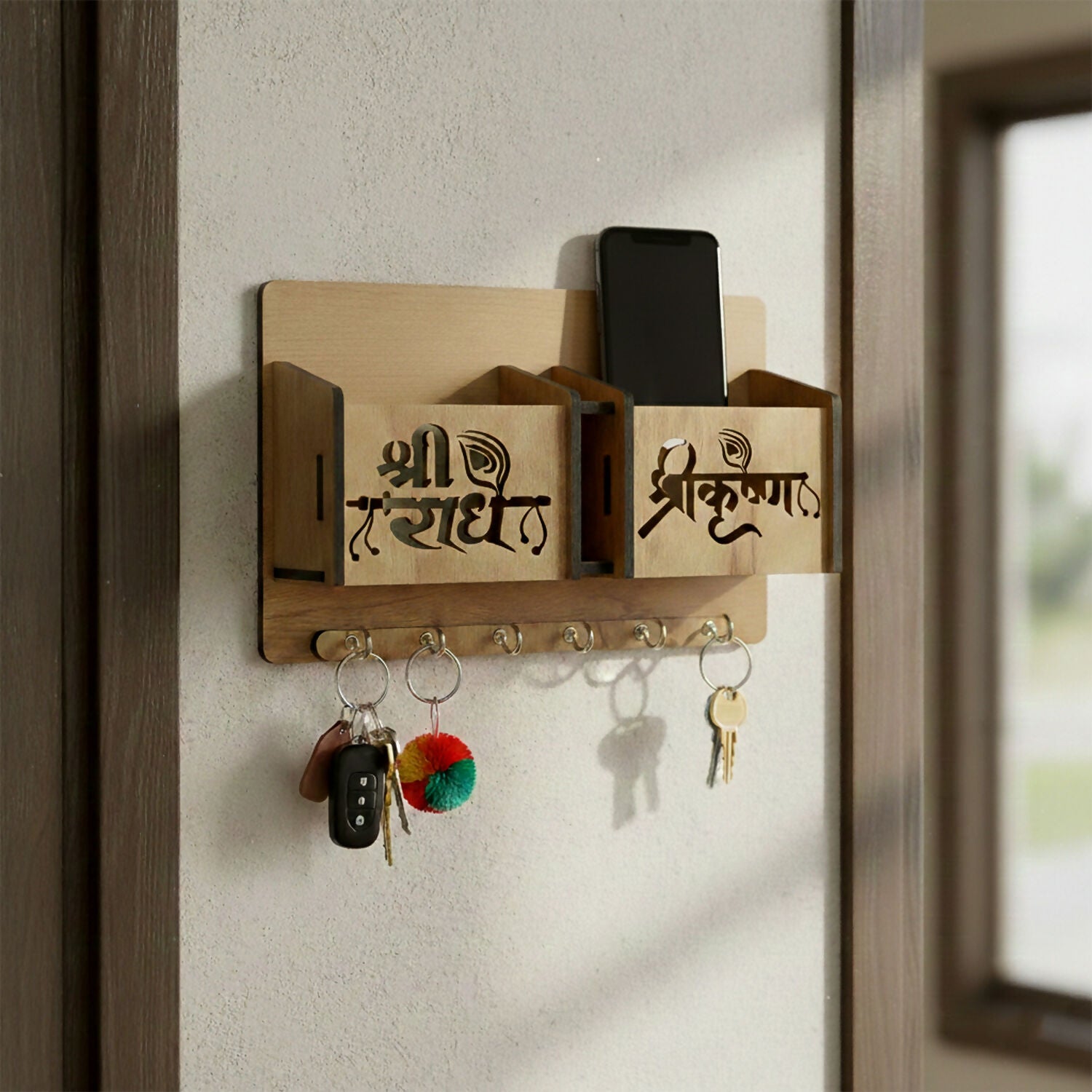 Close-up of engraved decorative lettering on wooden key holder