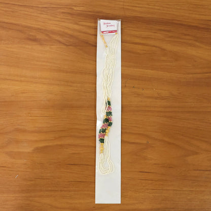 Handcrafted white mala necklace with colorful bead details on display