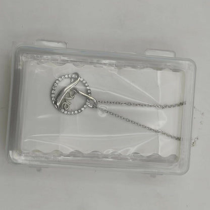 Model wearing the love script silver plated circle pendant necklace with adjustable chain