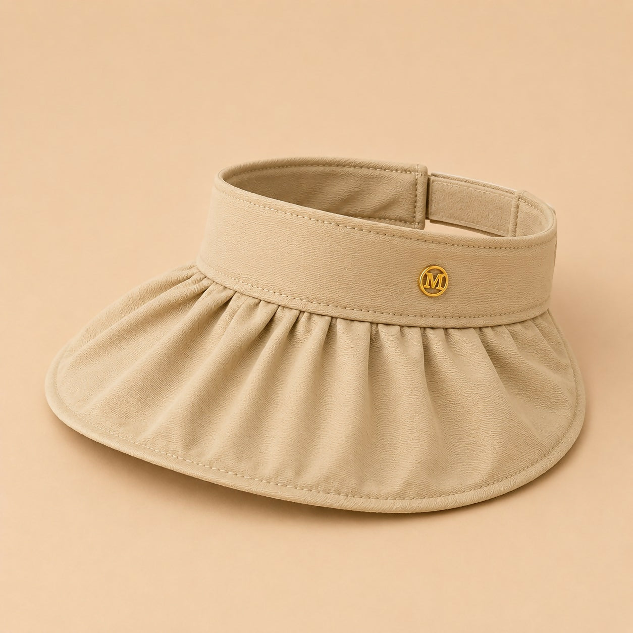 Folded beige women’s sun visor cap ready for travel