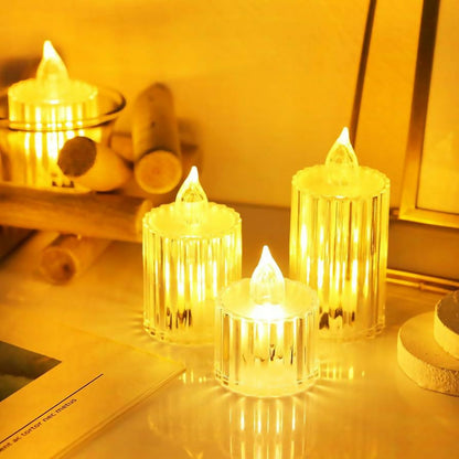 Three bright crystal-look LED candles on a light wooden surface with decorative items in warm lighting.