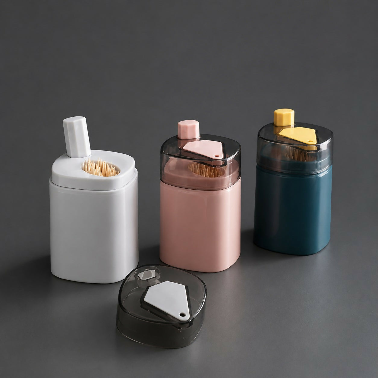 Compact toothpick dispenser with push button and dustproof lid