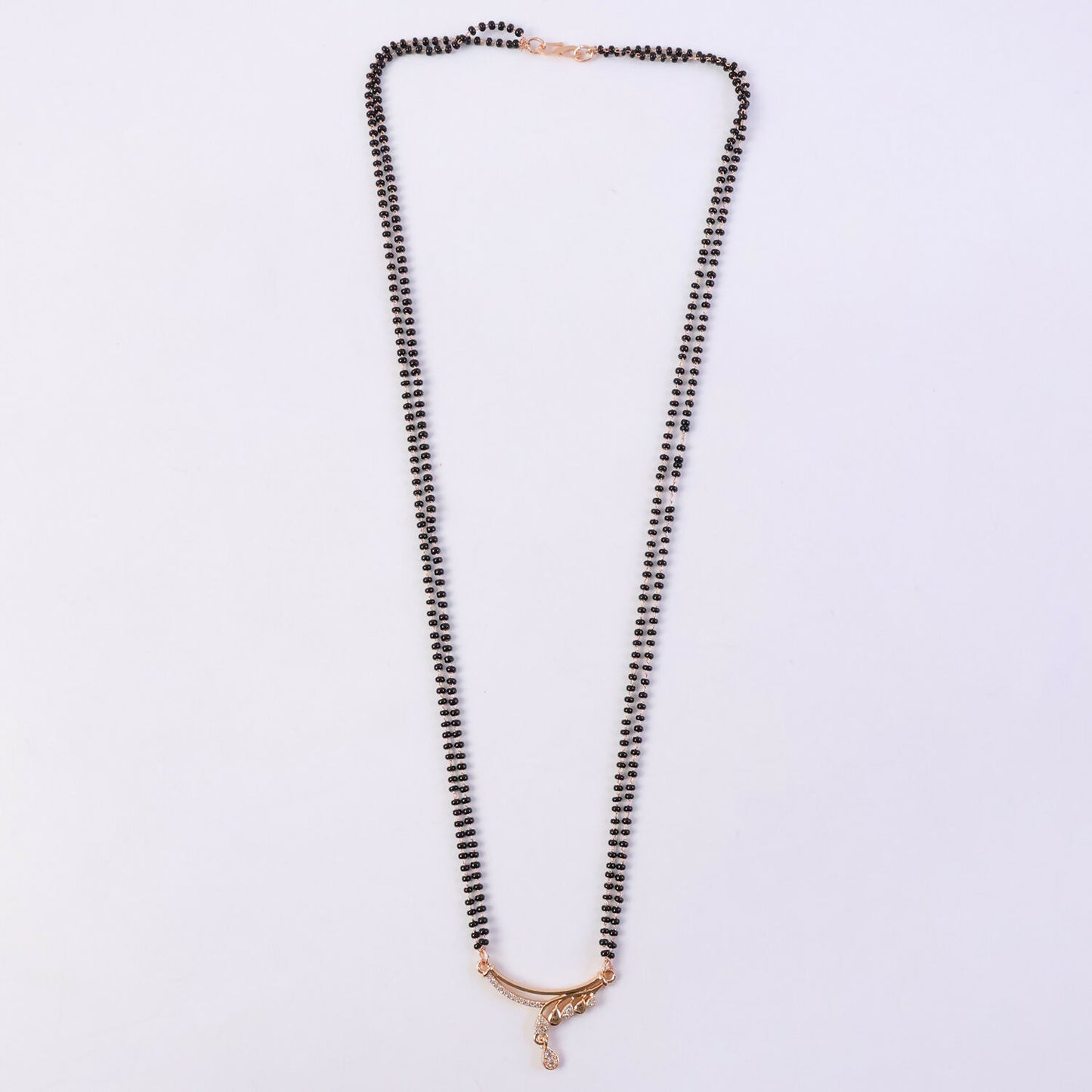 Close-up view of the CZ diamond-encrusted wave arc pendant on mangalsutra