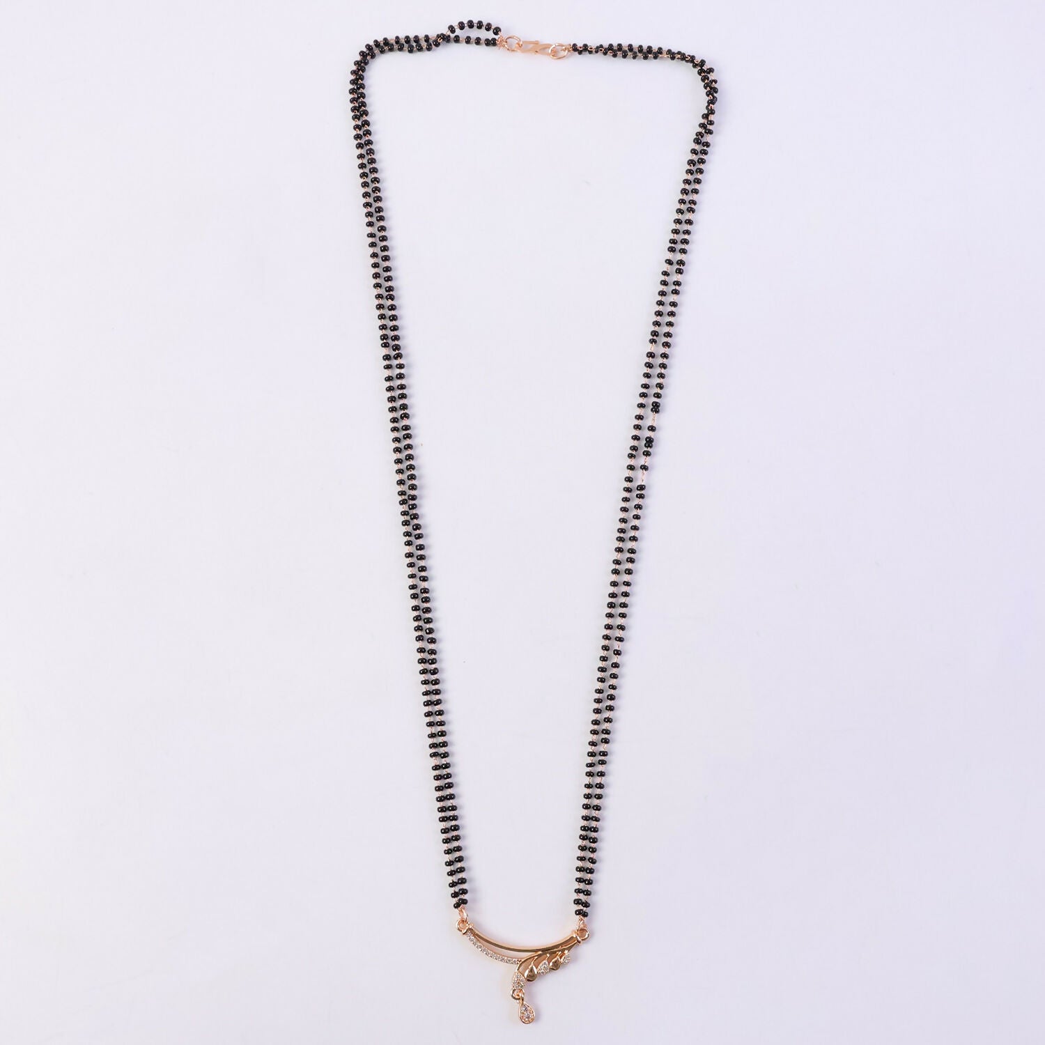 Close-up view of the CZ diamond-encrusted wave arc pendant on mangalsutra