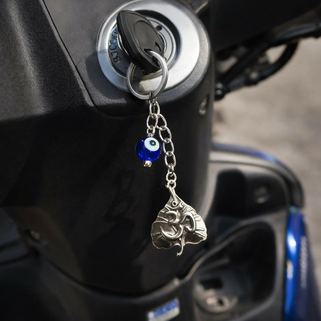 Om leaf evil eye keychain attached to a black bag