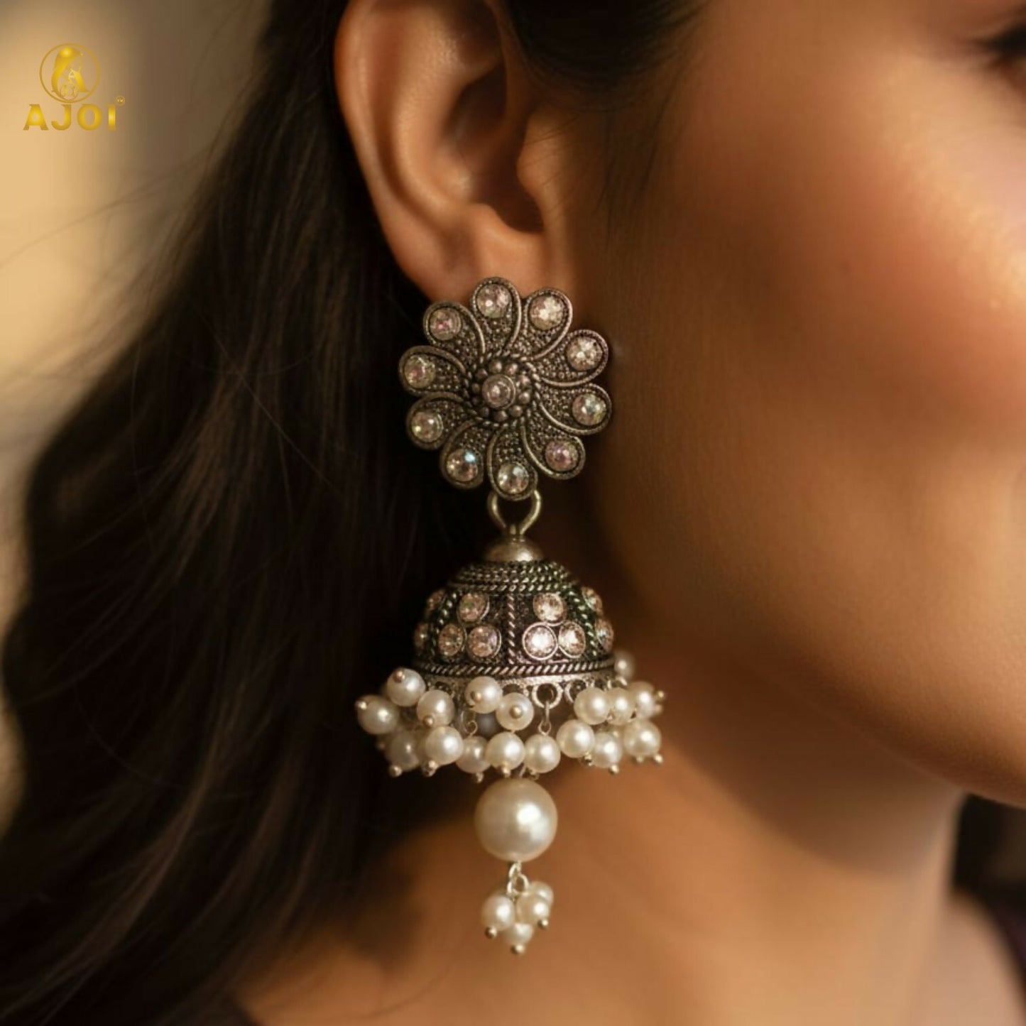 Front view of oxidised silver round jhumka earrings with pearl clusters