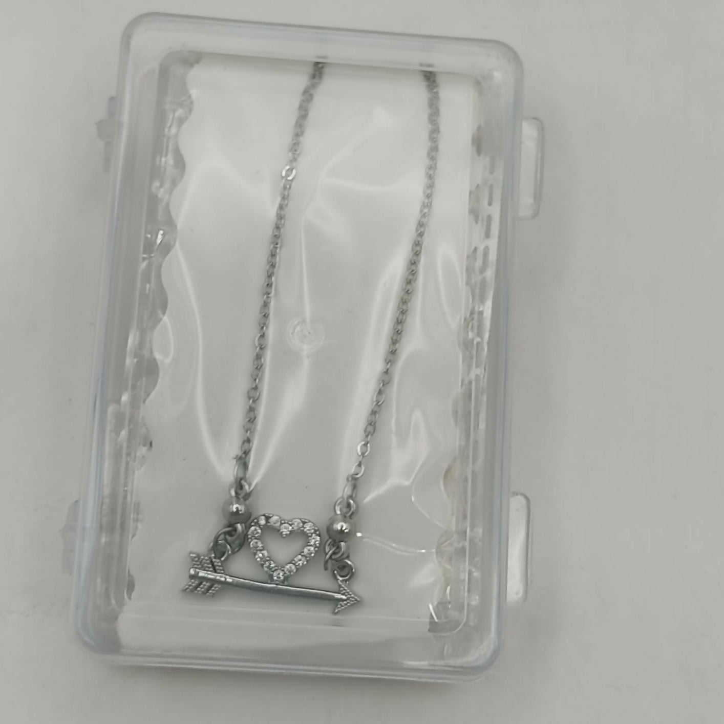 Elegant Heart & Arrow silver plated pendant necklace styled on neck with subtle shine