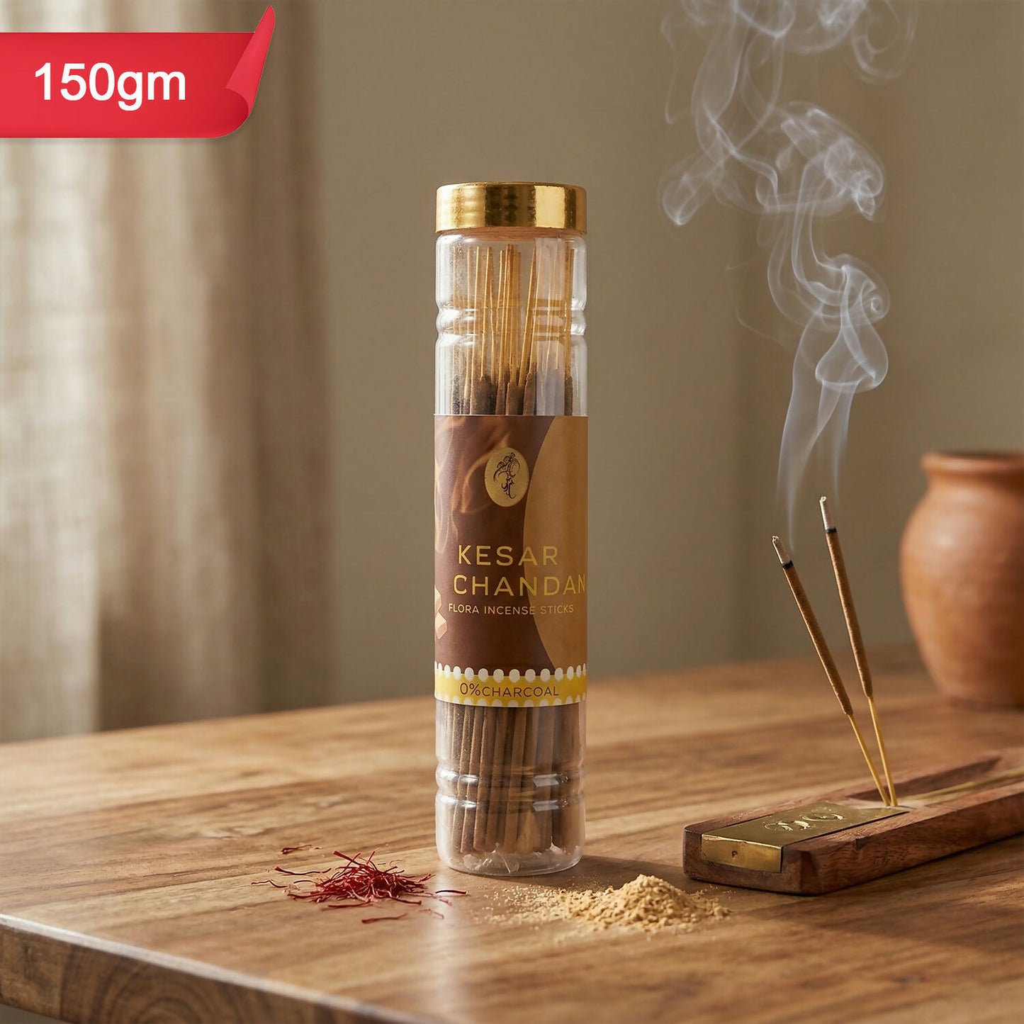 Hand holding Kesar Chandan incense sticks with charcoal-free label
