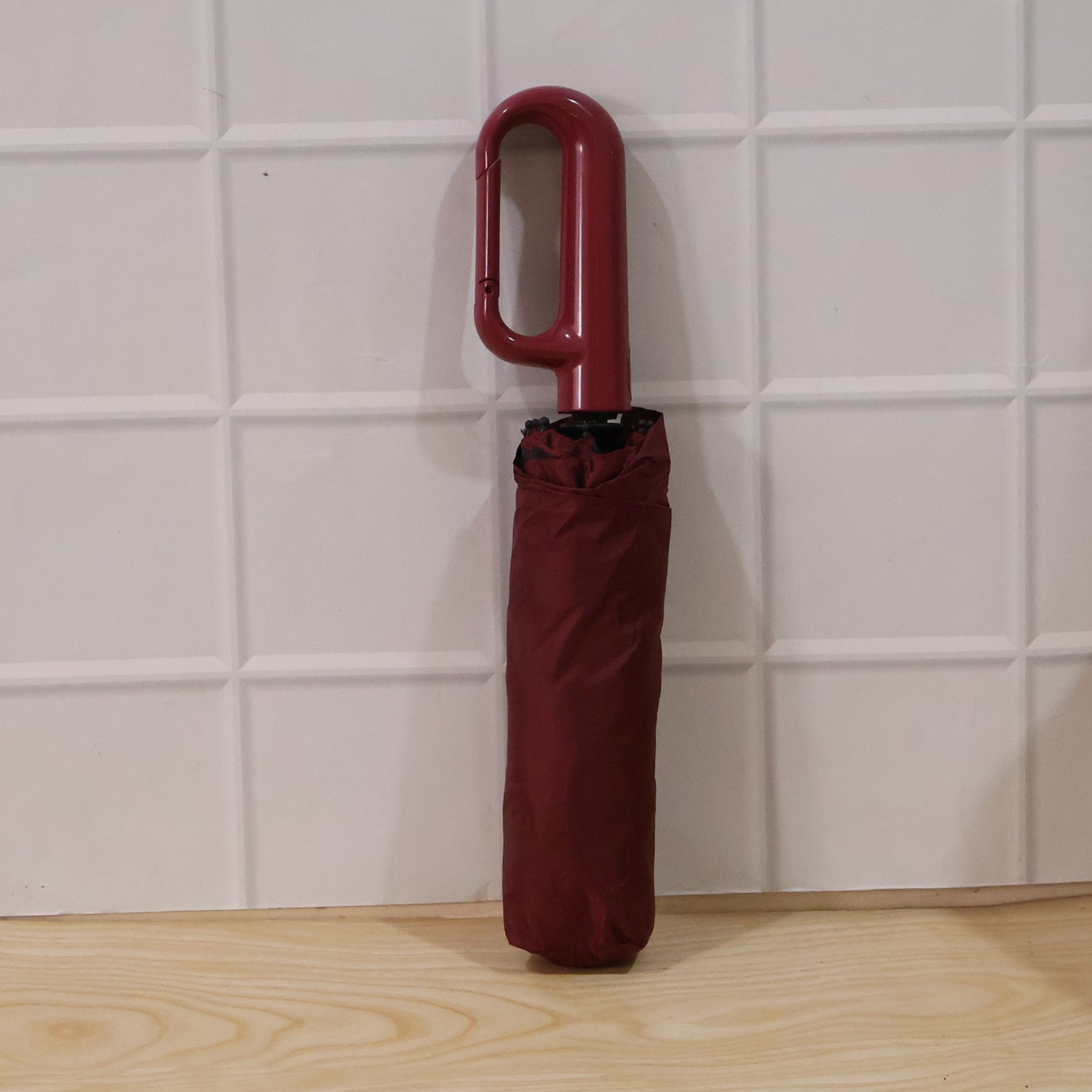 Portable windproof umbrella shown partially open for travel convenience