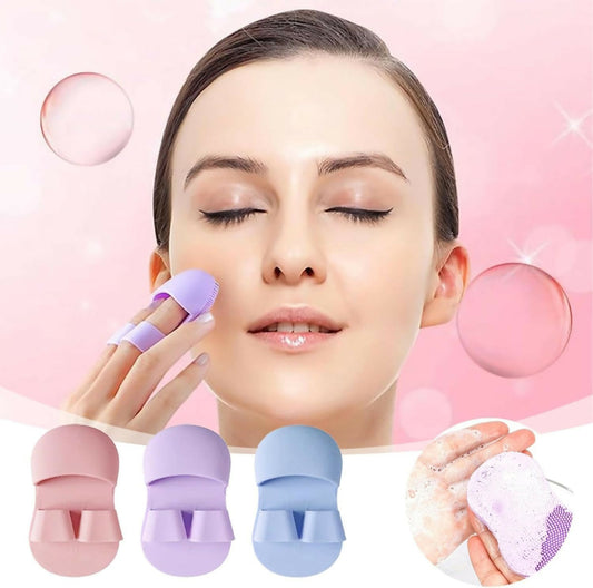 A woman uses a purple silicone finger brush on her cheek, with pink, purple, and blue brushes below.