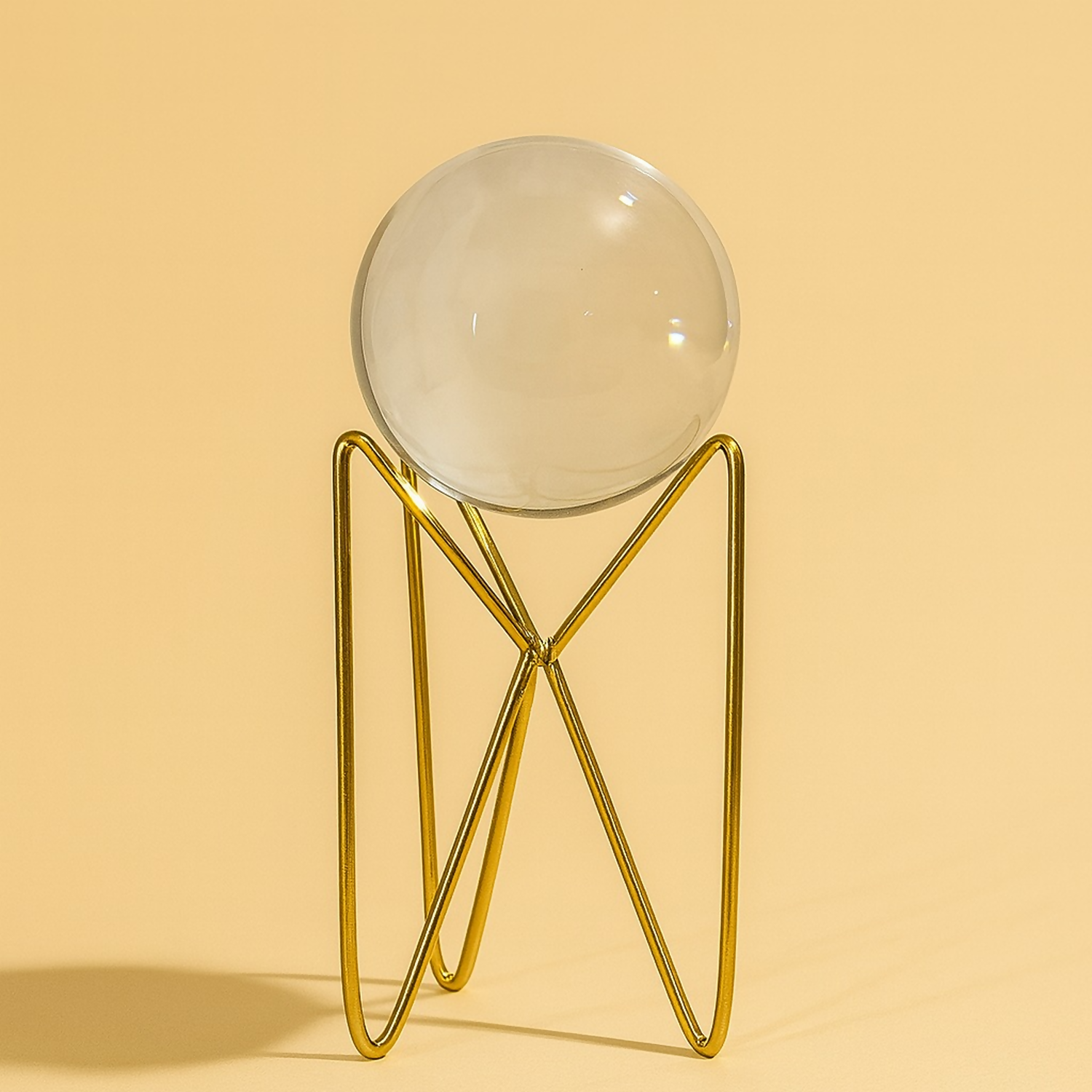 Modern decorative crystal ball with shiny golden metallic stand