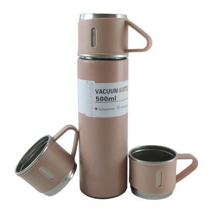 A pink vacuum flask stands upright with two matching cups, one tilted, on a plain white background.