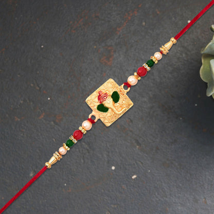Golden Ganpati Rakhi with colorful bead accents