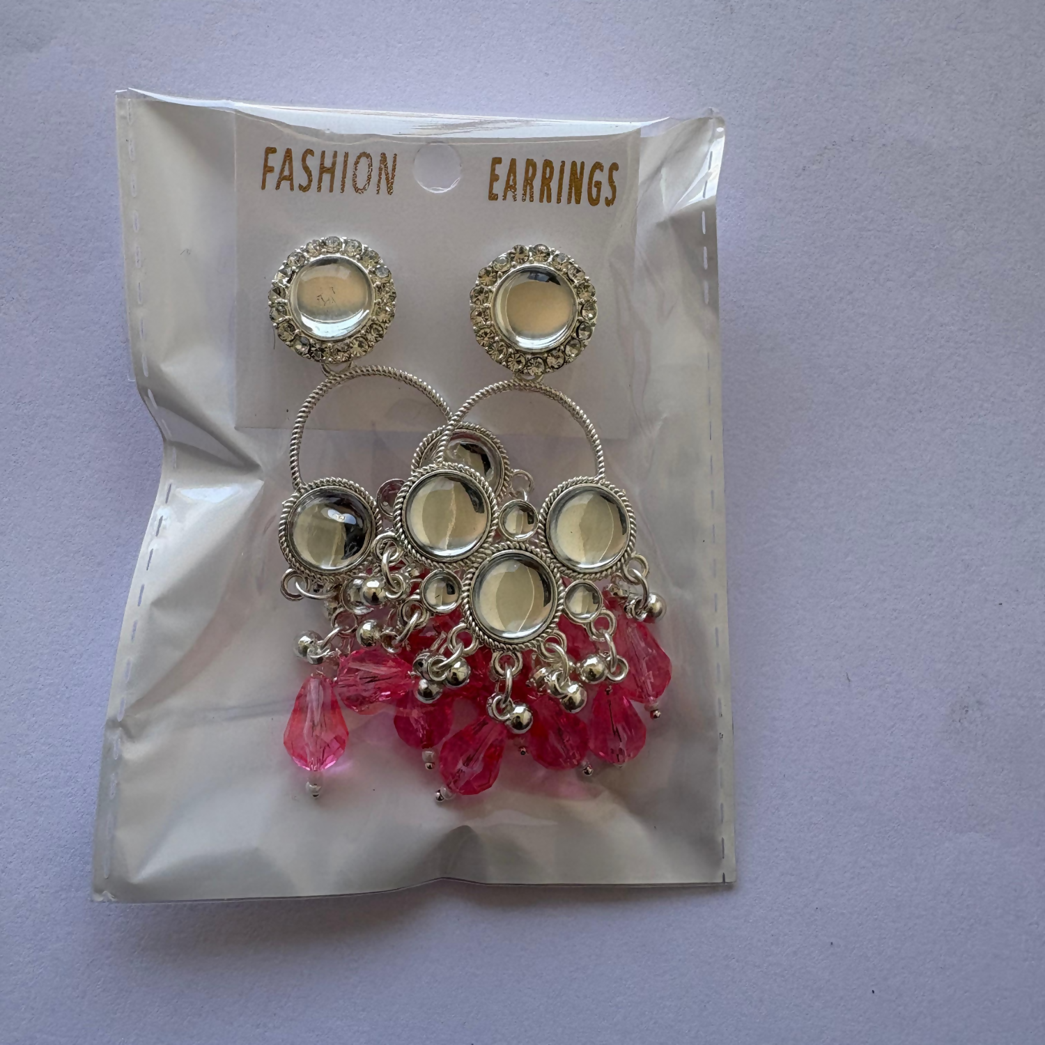 Display of Kundan pearl Chandbali earrings highlighting intricate silver alloy work