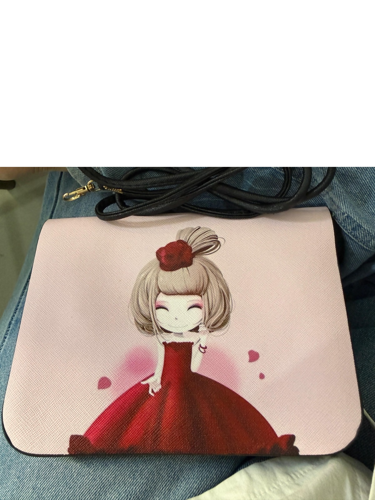 Pink cartoon girl print sling bag hanging on a hook