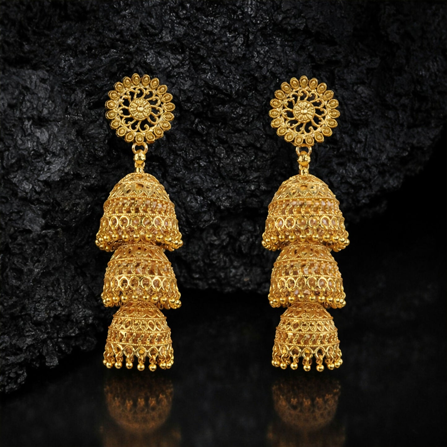 Detailed dome layers of traditional gold tone jhumka earrings