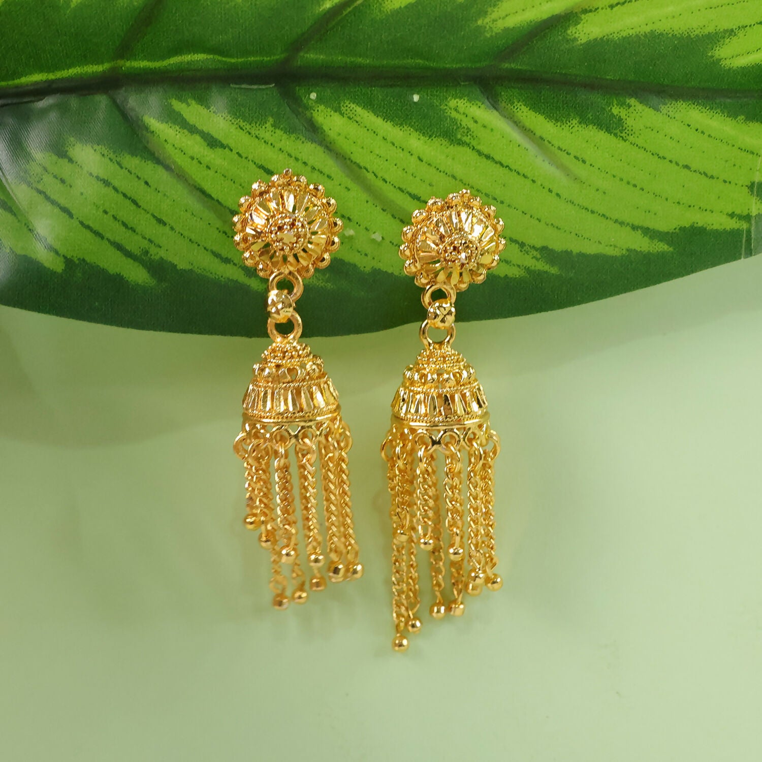 Gold plated long chain jhumka earrings displayed on a white background