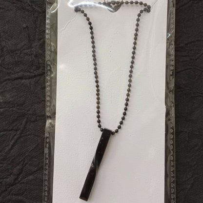 Model wearing black twisted bar chain pendant