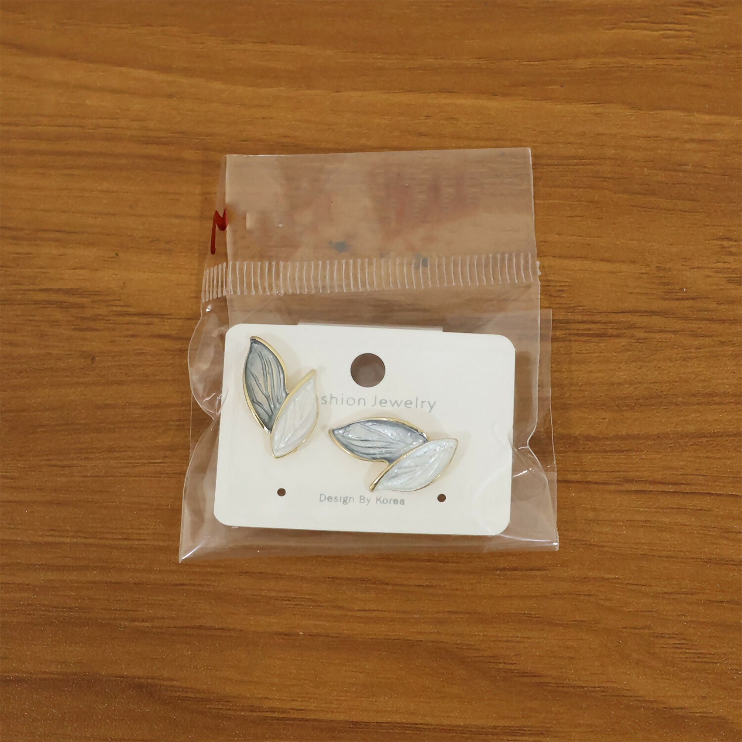 Minimalist earrings styled with white shirt outfit