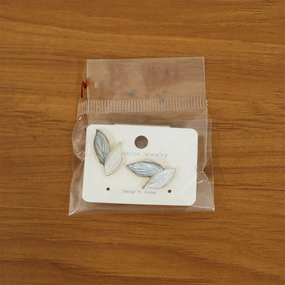 Minimalist earrings styled with white shirt outfit