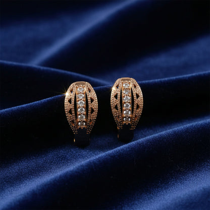 Close-up of gold finish hoop earrings studded with cubic zirconia stones