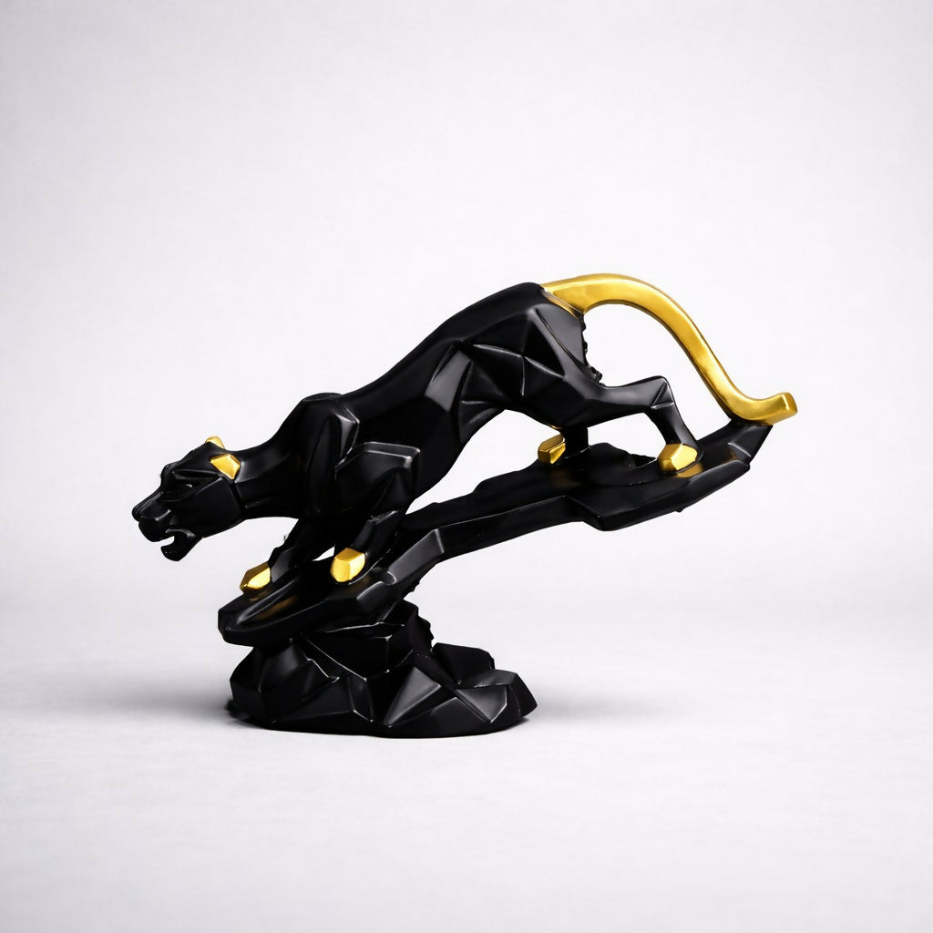 Close-up of black and gold abstract panther home decor statue