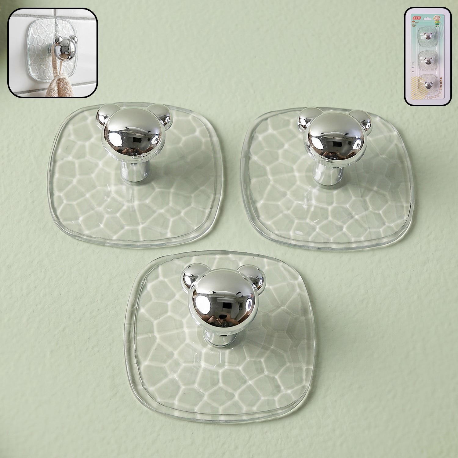 Clear plastic adhesive wall hooks mounted on white wall holding keys and bags