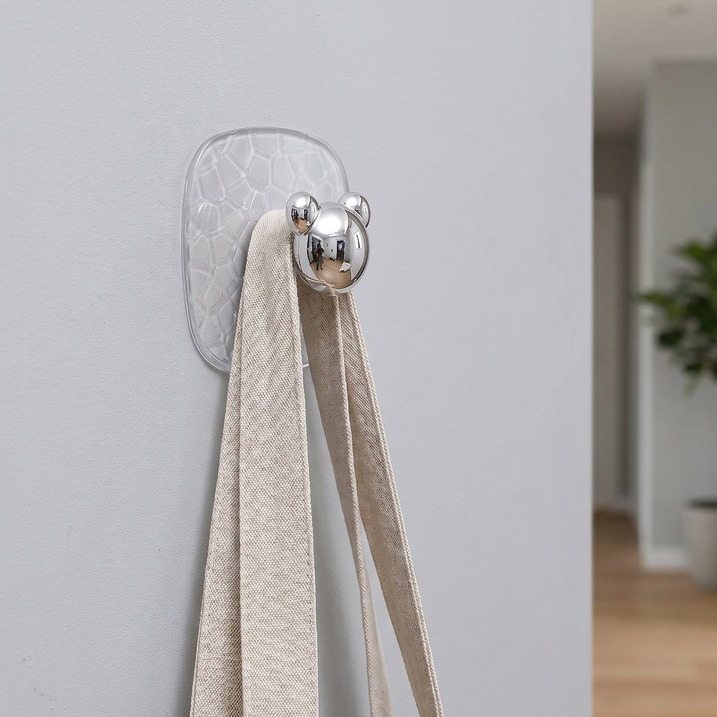 Clear plastic adhesive wall hooks used to hang various household items