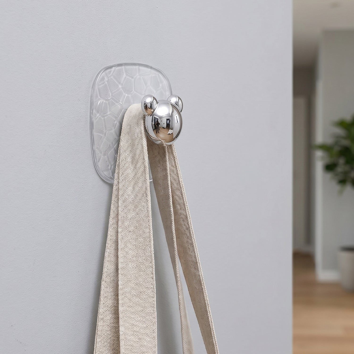 Clear plastic adhesive wall hooks used to hang various household items