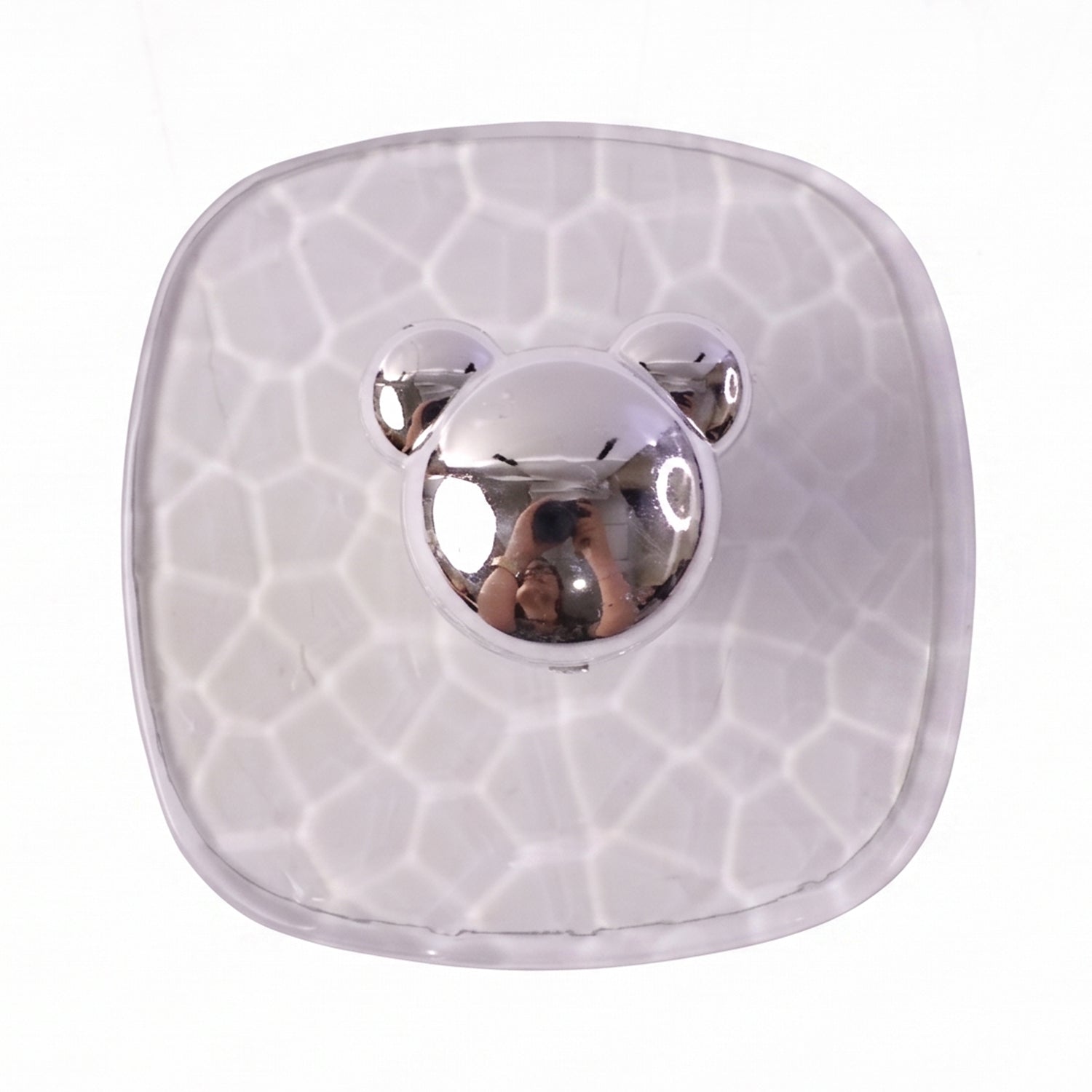 Multiple clear adhesive wall hooks attached on a bathroom wall