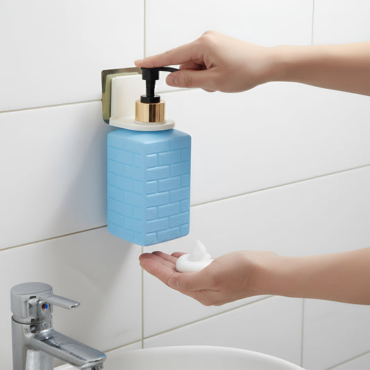 Wall-mounted soap dispenser installed in bathroom