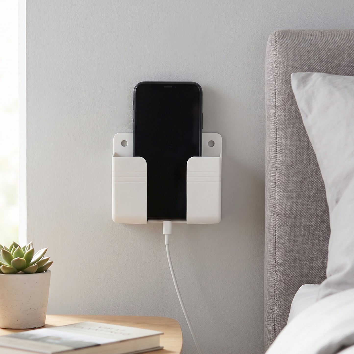Phone resting in the wall holder while charging