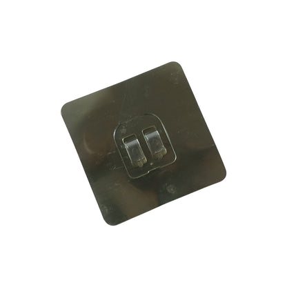 Transparent adhesive wall hook attached to a glass surface