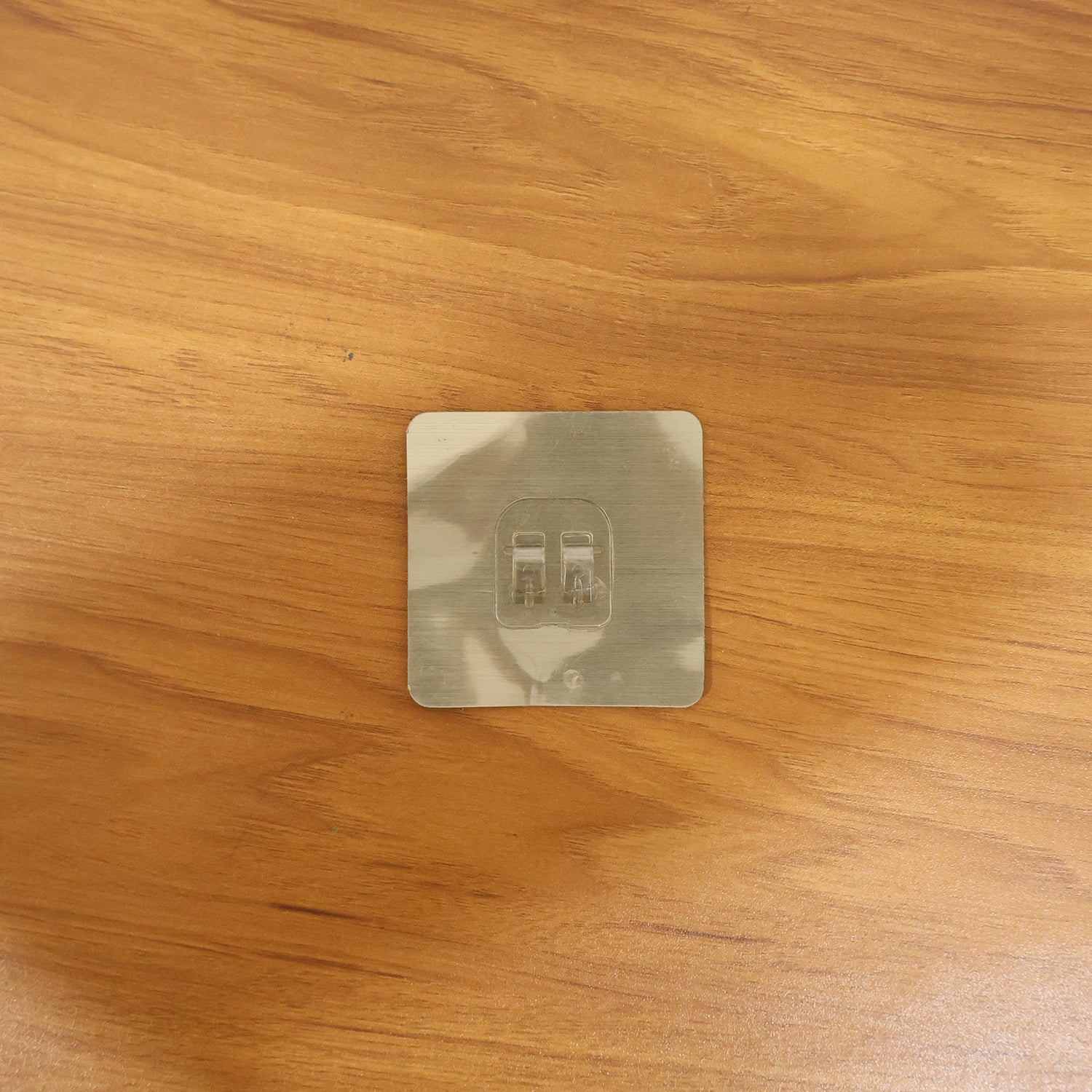 Transparent adhesive wall hook in real-life use