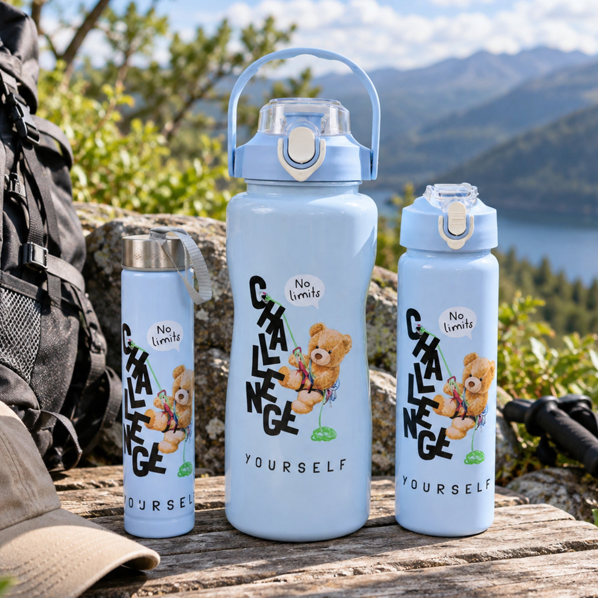 Three light blue water bottles on a wooden surface with a backpack and a lake and mountains in the background.