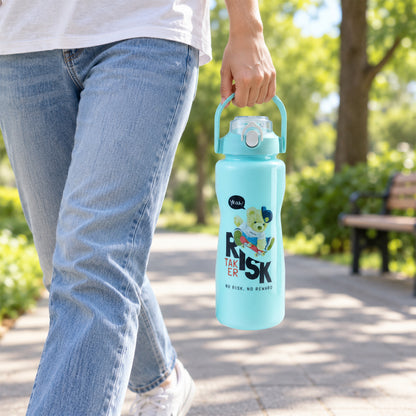 A person walking outdoors, holding a large light blue water bottle with a handle.