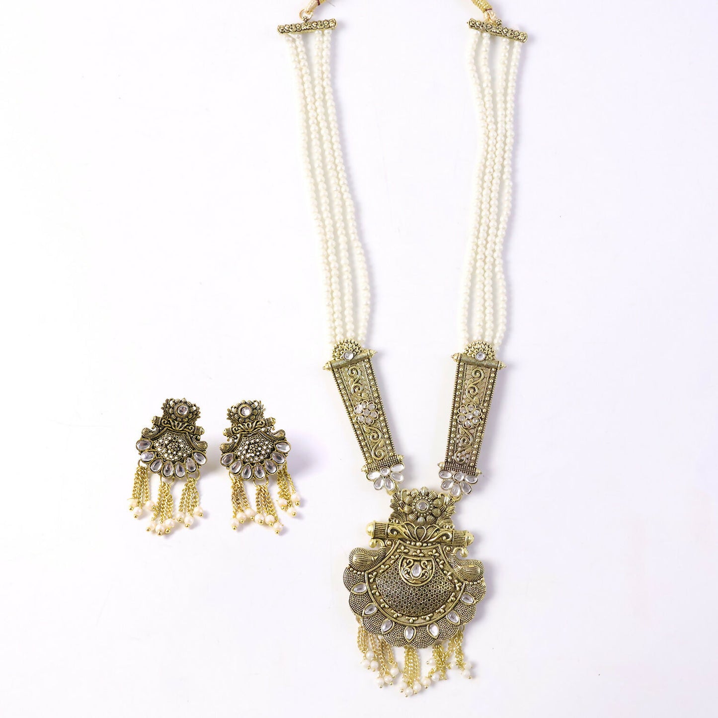 Detailed view of gold necklace pendant and pearls