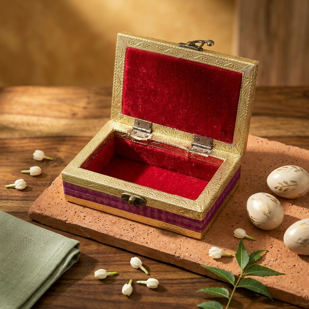 Open decorative magenta dry fruit box with golden embossed edges