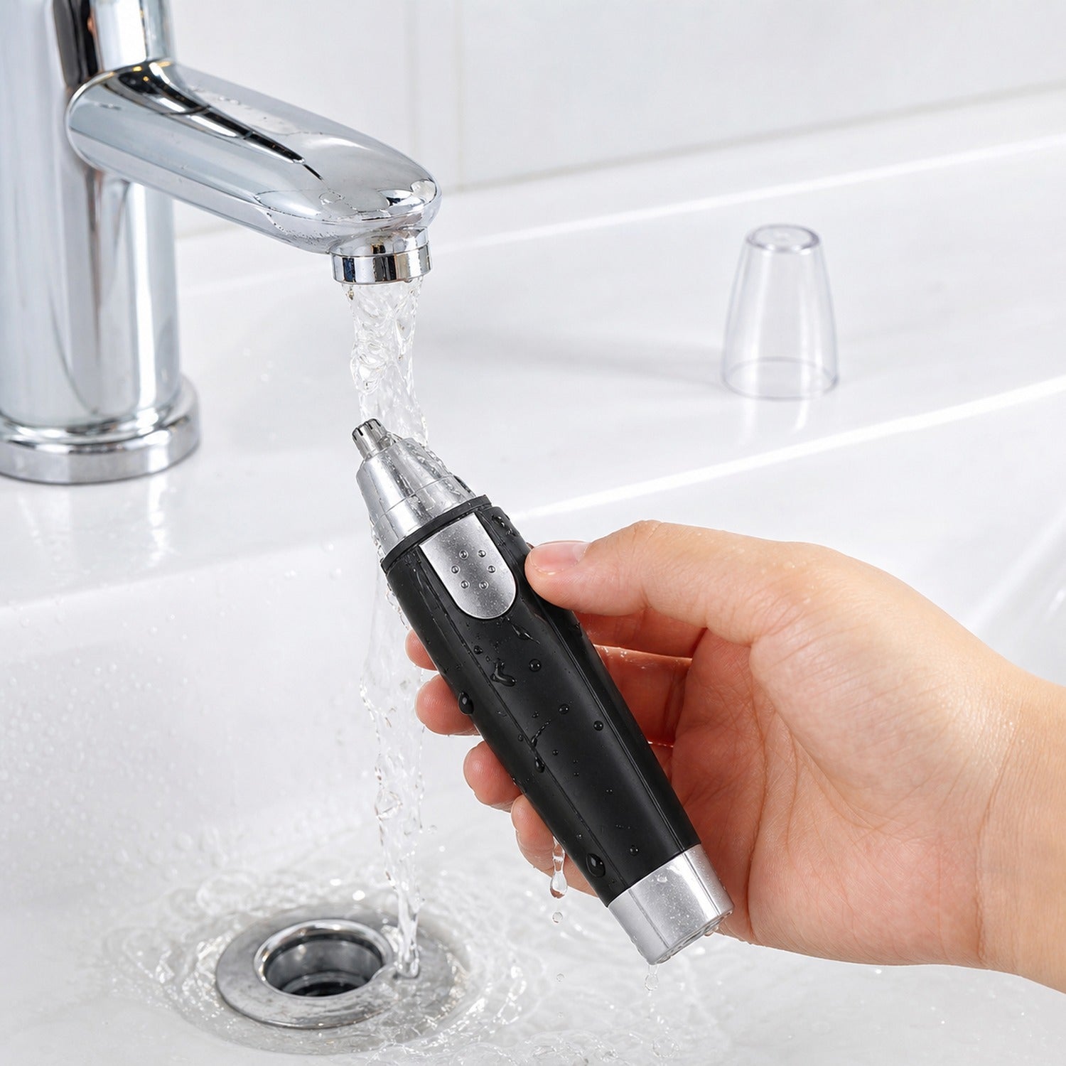 Ear and nose hair trimmer next to batteries