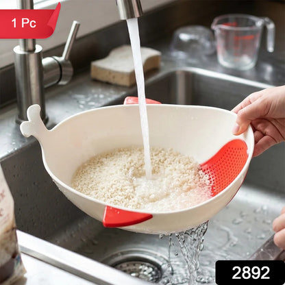 A person rinsing rice in a white whale-shaped bowl with red accents under a kitchen faucet, with a red "1 Pc" label and