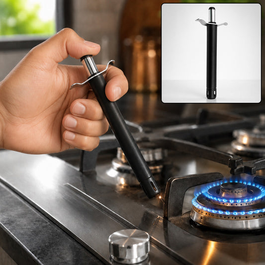 A hand holds a black and silver gas lighter, igniting a blue flame on a stainless steel stovetop burner.